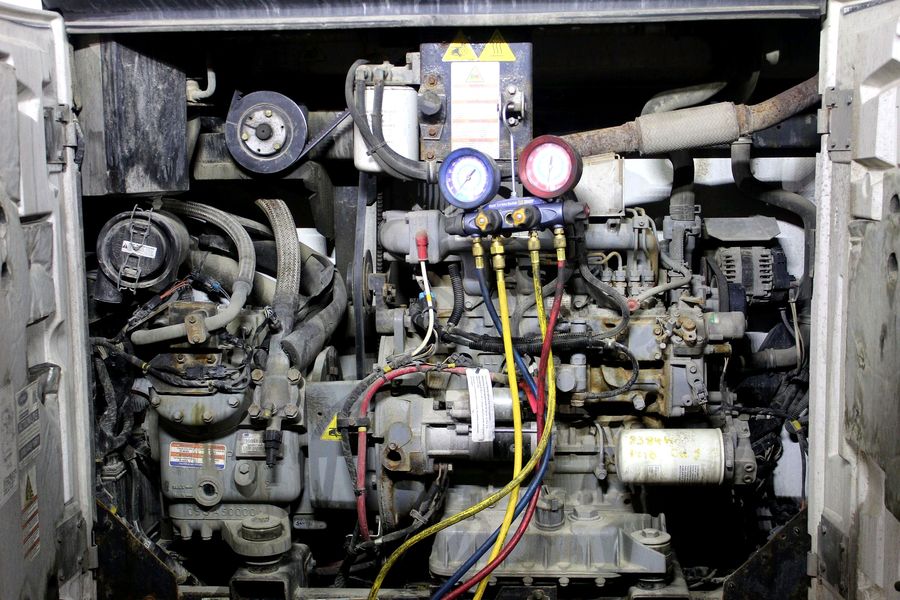 Thermo King reefer unit opened up with manifold gauges connected for diagnosis